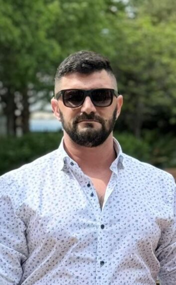 man wearing a white button down shirt with sunglasses