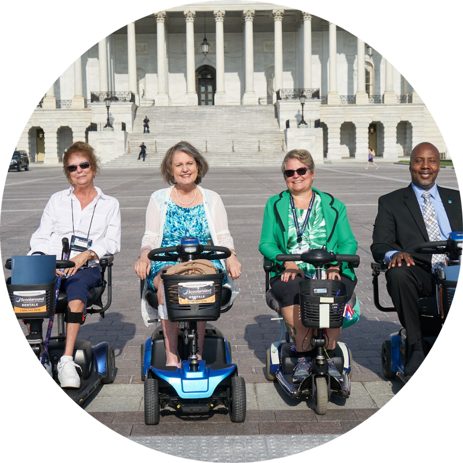 individuals in a scooter posing for a photo