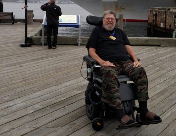 John Hutchinson in a wheelchair on a dock