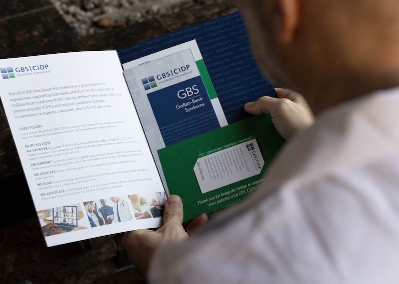A person reads an informational pamphlet about GBS.